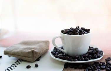 Cup of coffee bean and notebook