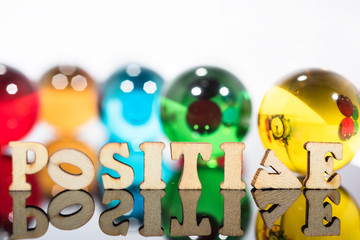 Abstract composition with transparent glass balls and wooden letters.