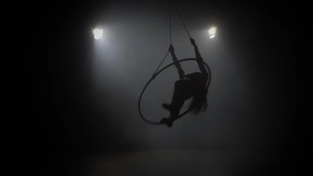 Young girl performs the acrobatic elements in the air ring 008