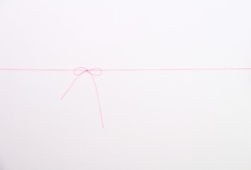 pink thread on white background