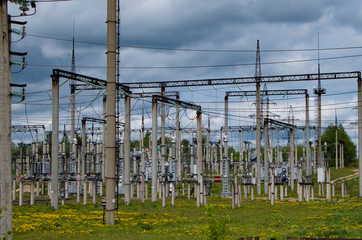 Electricity distribution station. Lots of wires, poles and shields.