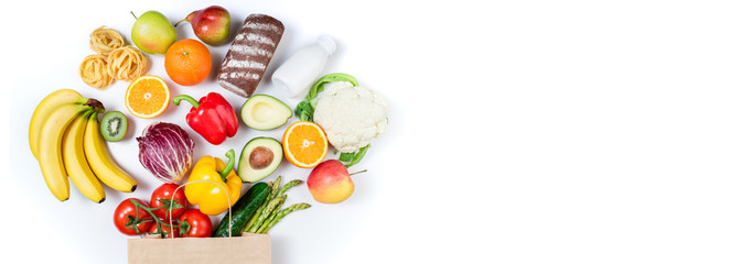 Fototapeta na wymiar Healthy food background. Healthy food in paper bag bread, milk, vegetables and fruits on white background. Shopping food supermarket concept. Long format with copy space