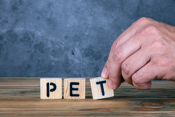 Pet - word from wooden letters on wooden table