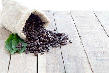 coffee bean with leaves on wood background