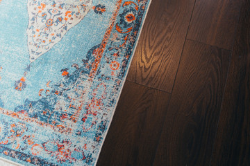 Laminate parquete floor. Light wooden texture. Beige soft carpet. Warm interior design