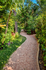 Naklejka premium Tropical gardens around a swimming pool in Pattaya, Thailand