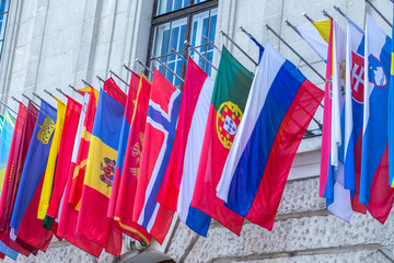 Flags of almost all countries of the northern hemisphere on the facade the building of Hofburg palace in Vienna, Austria.