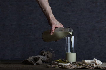 Homemade pistachio nut milk in a glass bottle.