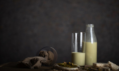 Homemade pistachio nut milk in a glass bottle.
