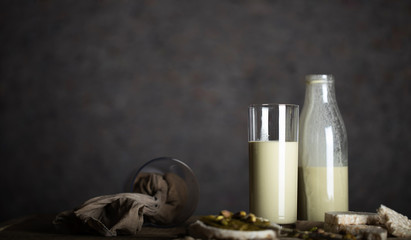 Homemade pistachio nut milk in a glass bottle.