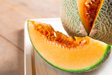 Fresh sweet orange melon on the wooden table