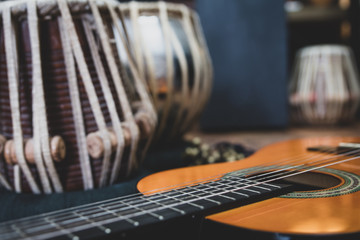 Acoustic guitar, cajon and tabla - view of the musical instruments used for fusion eastern and...