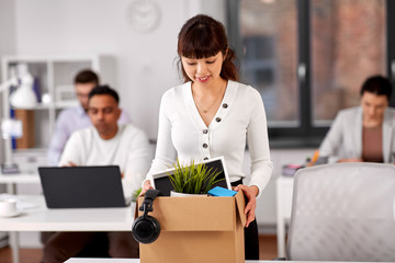 business, new job and corporate concept - happy smiling asian businesswoman or female employee with her personal stuff at office