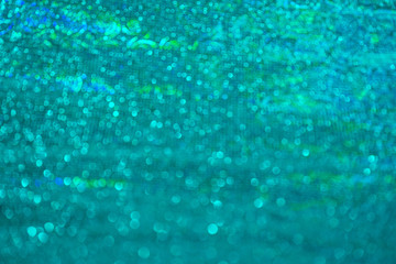 Blurred bokeh light green blue azure turquoise holographic background, Christmas and New Year...