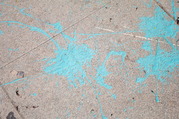 Obraz na płótnie Canvas Blue paint splattered on a sidewalk