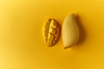 Juicy Mango on a blue background with a slice cut into slices. Top view with place for save pasta.