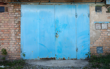 old metal door to the car garage