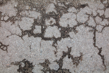 Cracks and pit on the asphalt road as background