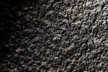 Black wall of sand and concrete as an abstract background