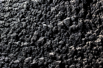 Black wall of sand and concrete as an abstract background