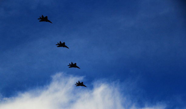 A group of fighters is flying in the blue sky