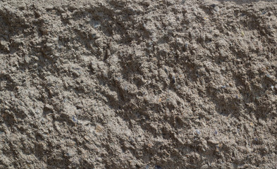 Background of a concrete wall of gray color with irregularities