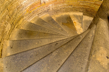 An ancient spiral staircase with stone steps