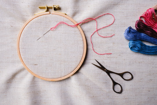 Flat lay with wooden embroidery hoops on a canvas background. Top view of a mockup