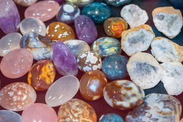Heap of various colored gems. Colorful gemstones. Natural Polished Gemstone Semi Precious Rocks Colorful Background Texture Close Up Phot. vertical photo
