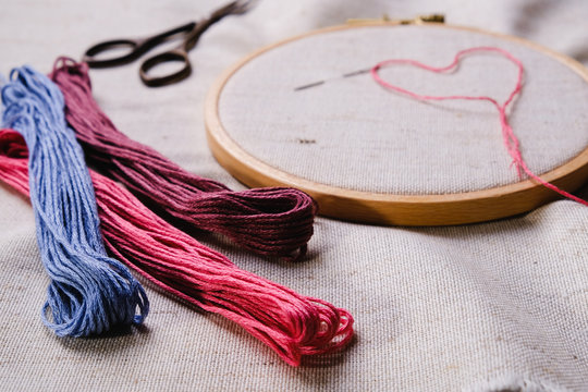 Embroidery set. White linen fabric, embroidery hoop, colorful threads and needls. Copy space