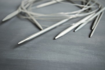 Circular knitting needles on gray background. 
