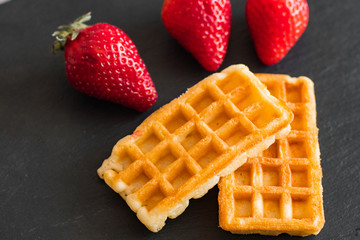 Close up of  belgian waffles with strawberries on the table 