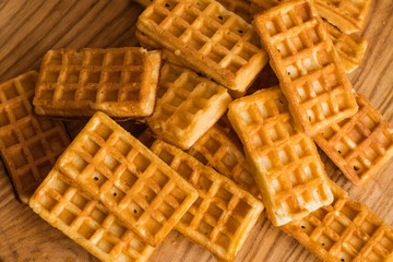 close up of many Belgian waffles on the wooden table 