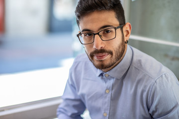 Obraz premium Portrait of young man with glasses and blue shirt