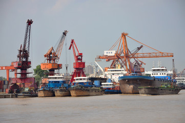 Ships at port of Nanjing by the bank of Yangtze River. Port of Nanjing is the largest inland port of China, Jiangsu Province, China.