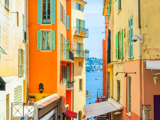 Fototapeta na wymiar Bright yellow houses in the Villefranche-sur-Mer, of the Cote d'Azur, France