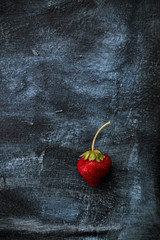 fresh strawberrie on dark blue and black background