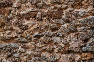 Obraz premium Background of a medieval wall made of old rustic stone