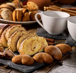 Cookies heart shape, sand rolled biscuit and cinnamon stick on wood table served dessert spoon at kitchen in rustic style. Morning sun flare. Preservation of sugar balance.