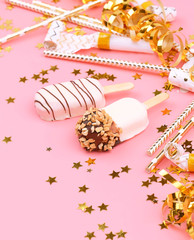 ice cream party. eskimo ice cream in chocolate glaze. tasty sweet treat, different kind of ice cream. Festive Holiday Composition with delicious ice-cream and gold decor on pink background. 