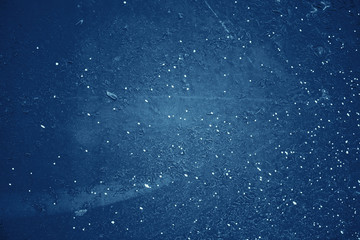 Vintage blue background. Rough painted wall of sapphire color. Imperfect plane of blue colored. Uneven old decorative toned backdrop of cyan tint. Texture of sapphirine hue. Ornamental stony surface.