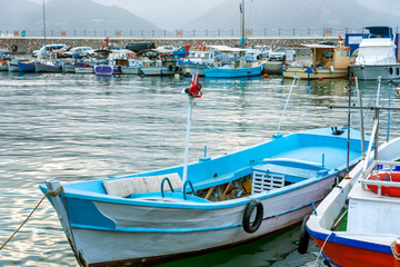 Wooden multi-colored fishing boats in the marina.