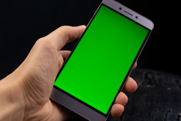 hand holding smart phone with blank screen isolated on white