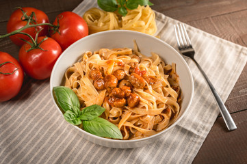 Italian spaghetti and meatballs topped with fresh basil