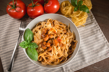 Italian spaghetti and meatballs topped with fresh basil