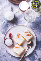 Few pieces of cake with cream topping with pieces of tangerines