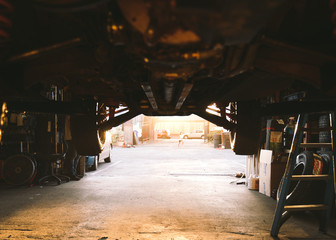 Bottom view of a truck inside a repairing garage.