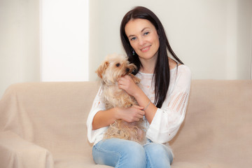 happy woman with dog on bed