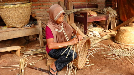bamboo basket craftsman while doing his work in a place, Batang / Jawa Tengah - Indonesia, May 26,...