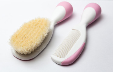 baby brush and comb on white background